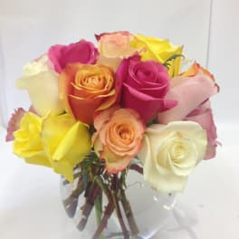 Bouquet of multicolored roses in a clear glass vase