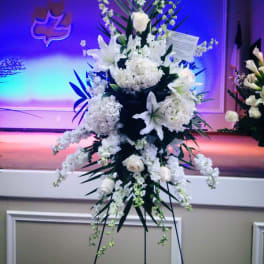 Tall white floral standing spray on an easel