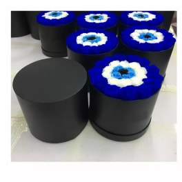 Black round boxes topped with blue and white rose arrangements