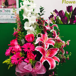 Pink and white mixed flower arrangement with lilies, roses, and gerbera daisies
