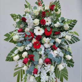 Large standing floral spray with red and white roses and white daisies