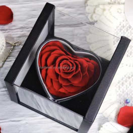 Red rose in a heart-shaped gift box