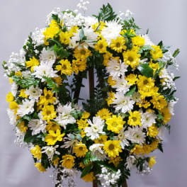 Yellow and white daisy wreath on a standing easel