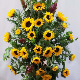 Tall sunflower arrangement with burgundy accents and greenery