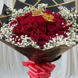 Bouquet of red roses with white baby's breath and a pink ribbon