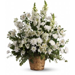 Tall white sympathy flower arrangement in a woven basket