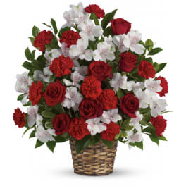 Basket arrangement of red roses, red carnations, and white alstroemeria