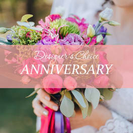 Pink and purple bouquet with ribbon in a bride's hands