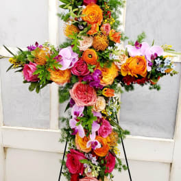 Cross-shaped floral standing spray with roses and orchids