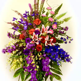 Tall mixed bouquet with red roses, pink lilies, and purple flowers