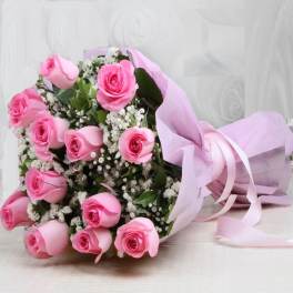 Bouquet of pink roses wrapped in pale pink paper