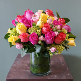 Bouquet of multicolored roses in a glass vase
