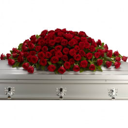 Red rose casket spray on a silver casket