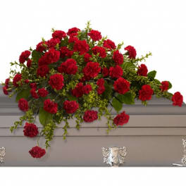 Red carnation arrangement on a gray casket