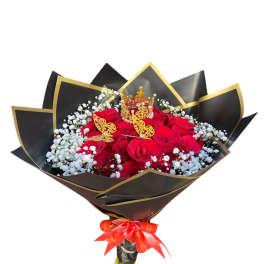 Bouquet of red roses with white baby's breath in black and gold wrap
