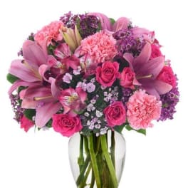 Pink and purple mixed bouquet in a clear glass vase