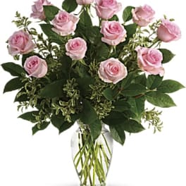 Arrangement of light pink roses in a clear glass vase