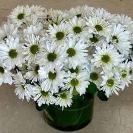 White daisy bouquet in a green glass vase