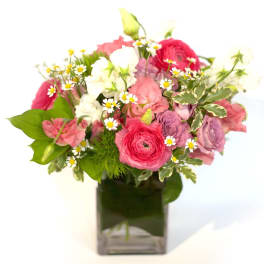 Pink and white mixed bouquet in a square glass vase