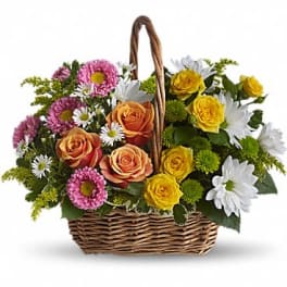 Basket arrangement with roses, daisies, and pink chrysanthemums