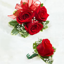 Red rose corsage and boutonniere with ribbon and baby's breath