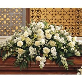 Large white floral casket spray with cascading blooms