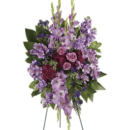 Tall standing spray of lavender and purple flowers on an easel
