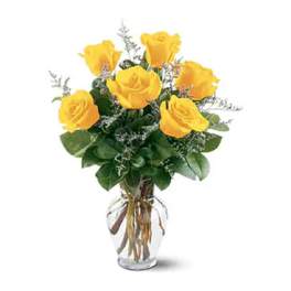 Yellow roses arranged in a clear glass vase
