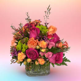 Mixed roses in a glass vase with pink and orange blooms