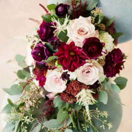 Bouquet of pale pink and deep burgundy flowers with eucalyptus