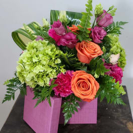 Pink and orange rose arrangement in a pink wooden box