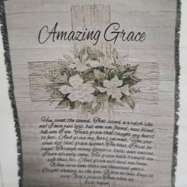 Framed wall hanging with white flowers and the words Amazing Grace