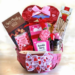 Basket of Valentine chocolates and cookies with pink ribbon