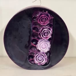 Round dark purple decorative piece with four purple roses