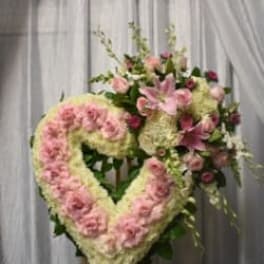 Heart-shaped floral wreath with pink roses and lilies