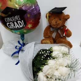 White rose bouquet with a graduation balloon and teddy bear