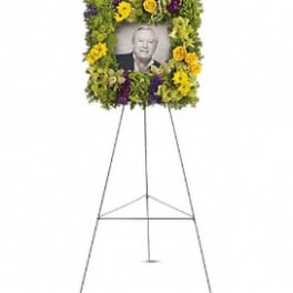 Standing floral tribute with a portrait in the center