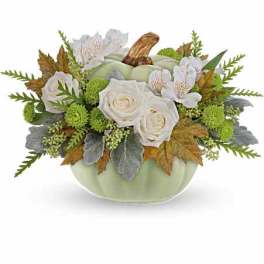 White roses and alstroemeria in a pale green pumpkin vase