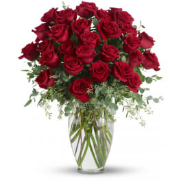 Large bouquet of red roses in a clear glass vase