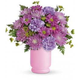 Pink and lavender chrysanthemum and carnation arrangement in a matte pink vase