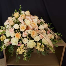 Large bouquet of cream and peach roses with ribbon on a box