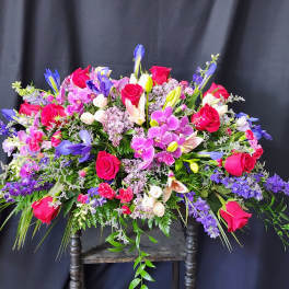 Large mixed bouquet of pink roses, purple orchids, and lilies