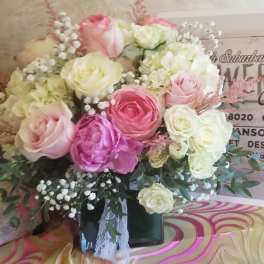 Bouquet of pink and white roses in a black vase