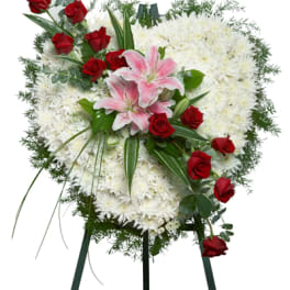 Heart-shaped standing spray of white mums with red roses and pink lilies