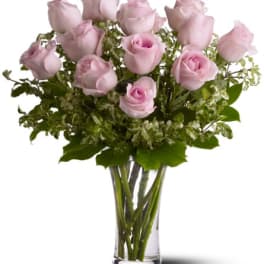 Pink roses arranged in a clear glass vase