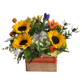 Mixed bouquet with sunflowers, lilies, and orange roses in a wooden box