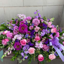 Large purple and pink floral spray with a lavender ribbon