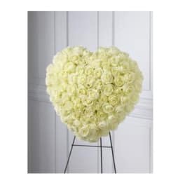 Heart-shaped arrangement of white roses on a stand