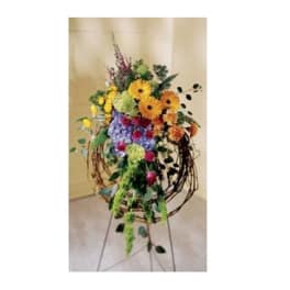 Tall mixed flower arrangement on a metal stand