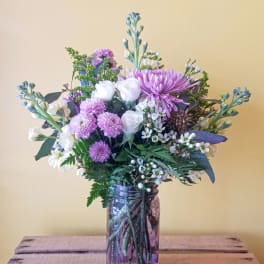 Lavender and white mixed bouquet in a glass jar vase